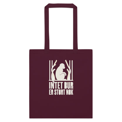 Mulepose med teksten Intet bur er stort nok og en abe bag tremmer i farven bordeaux, set forfra