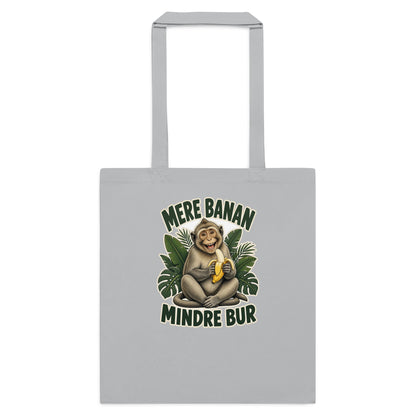 Mulepose med teksten Mere banan, mindre bur og en glad abe med en banan i farven lysegrå, set forfra