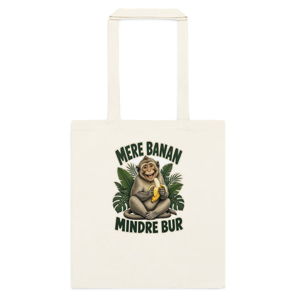 Mulepose med teksten Mere banan, mindre bur og en glad abe med en banan i farven natur, set forfra
