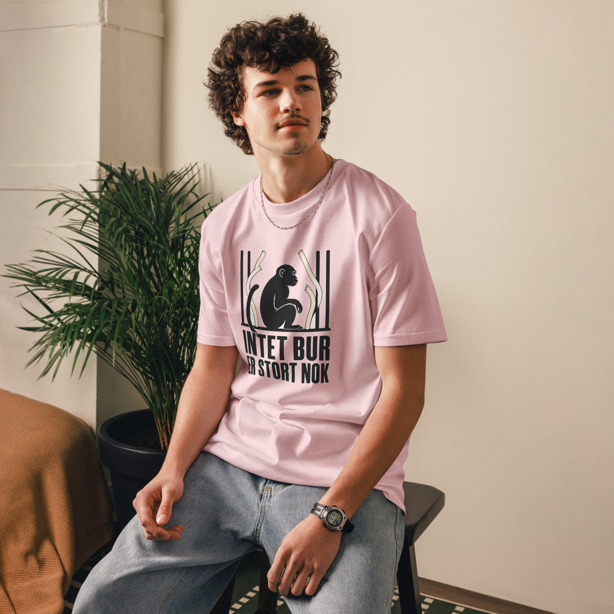 T-shirt med teksten Intet bur er stort nok i farven lyserød, båret af en ung mand