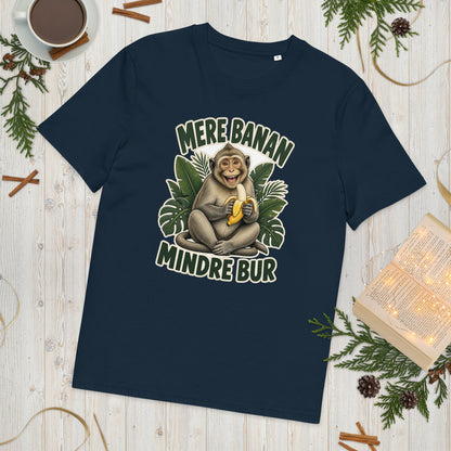 Abe t-shirt med teksten Mere banan, mindre bur i farven marineblå, lagt på et lyst træbord